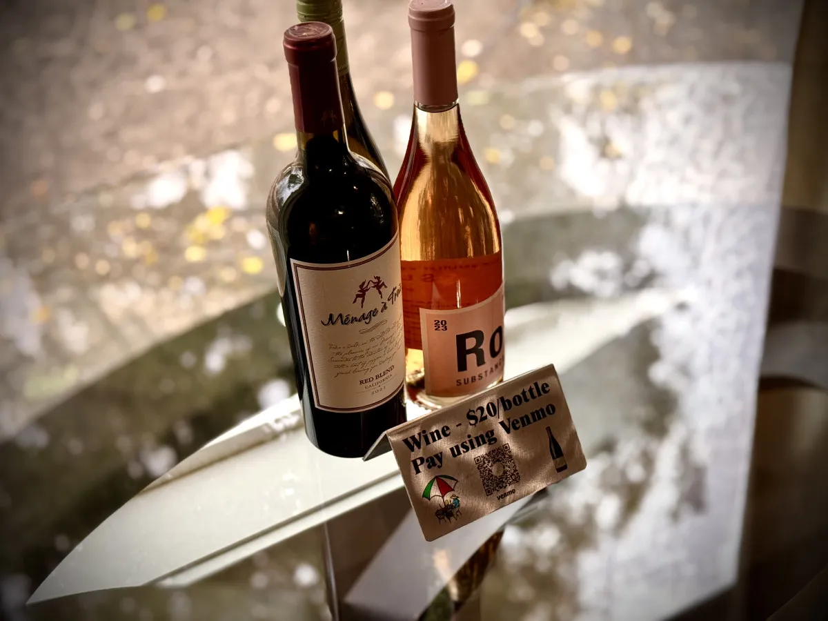 A cozy scene featuring two wine bottles on a table, inviting guests to enjoy wine tasting or social gatherings. The background suggests a comfortable and relaxed indoor setting, perfect for unwinding after a day of exploration.