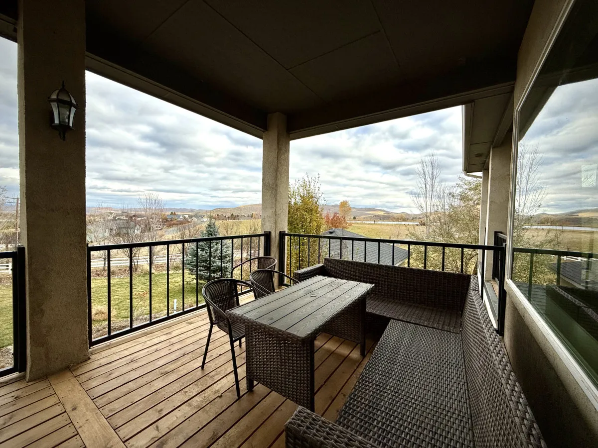 A stylish outdoor seating area with a dining table set on a patio, offering unobstructed views of the landscape. The mood is serene and inviting, ideal for meals, celebrations, or just enjoying the beauty of the outdoors.